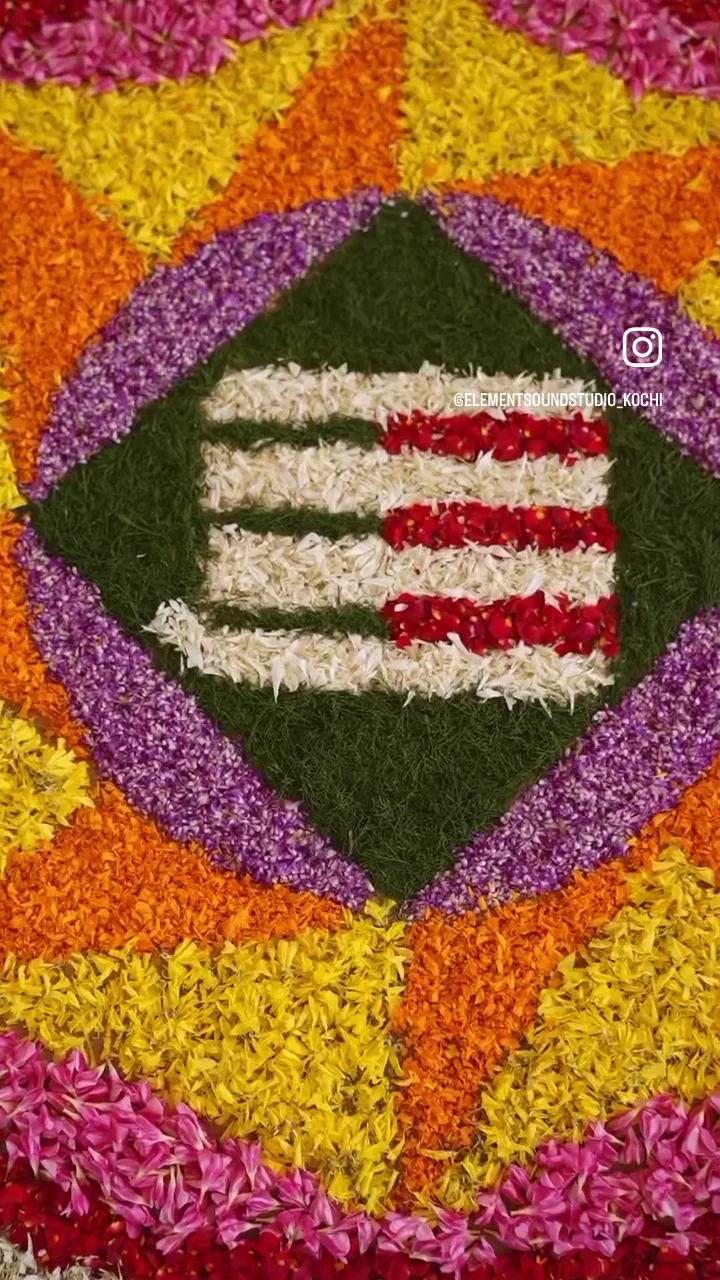 An Onam pookalam flower design featuring the Element logo